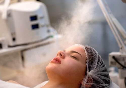 Patient receiving a professional facial steam treatment at Napa Solano Plastic Surgery for skin care and rejuvenation
