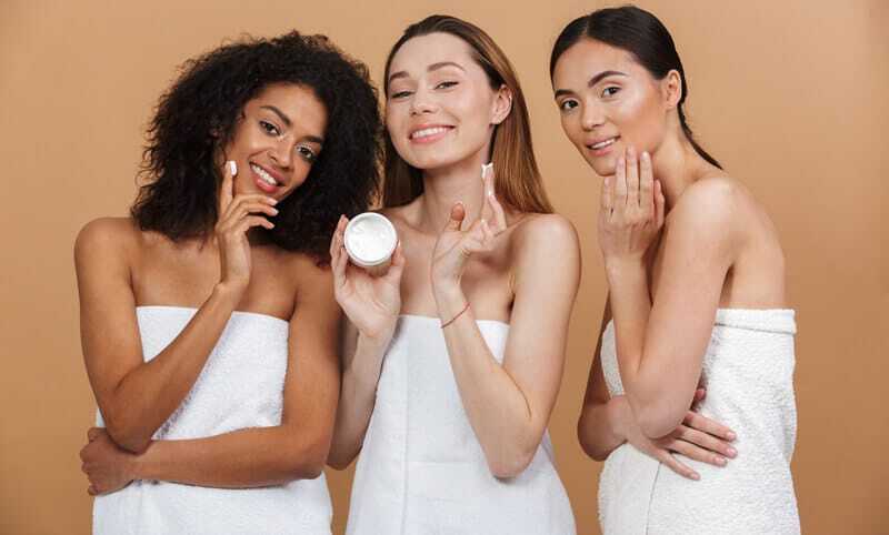aesthetician-services-medispa 3 women standing next to each other in white towels