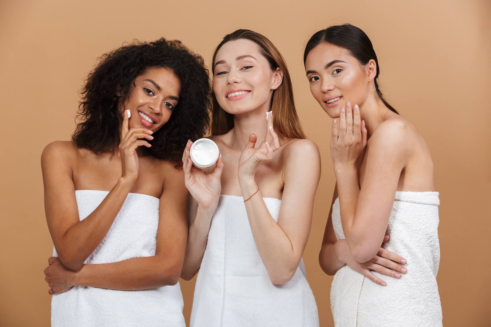 shutterstock_1101221135-aesthetician copy three women in towels with cream